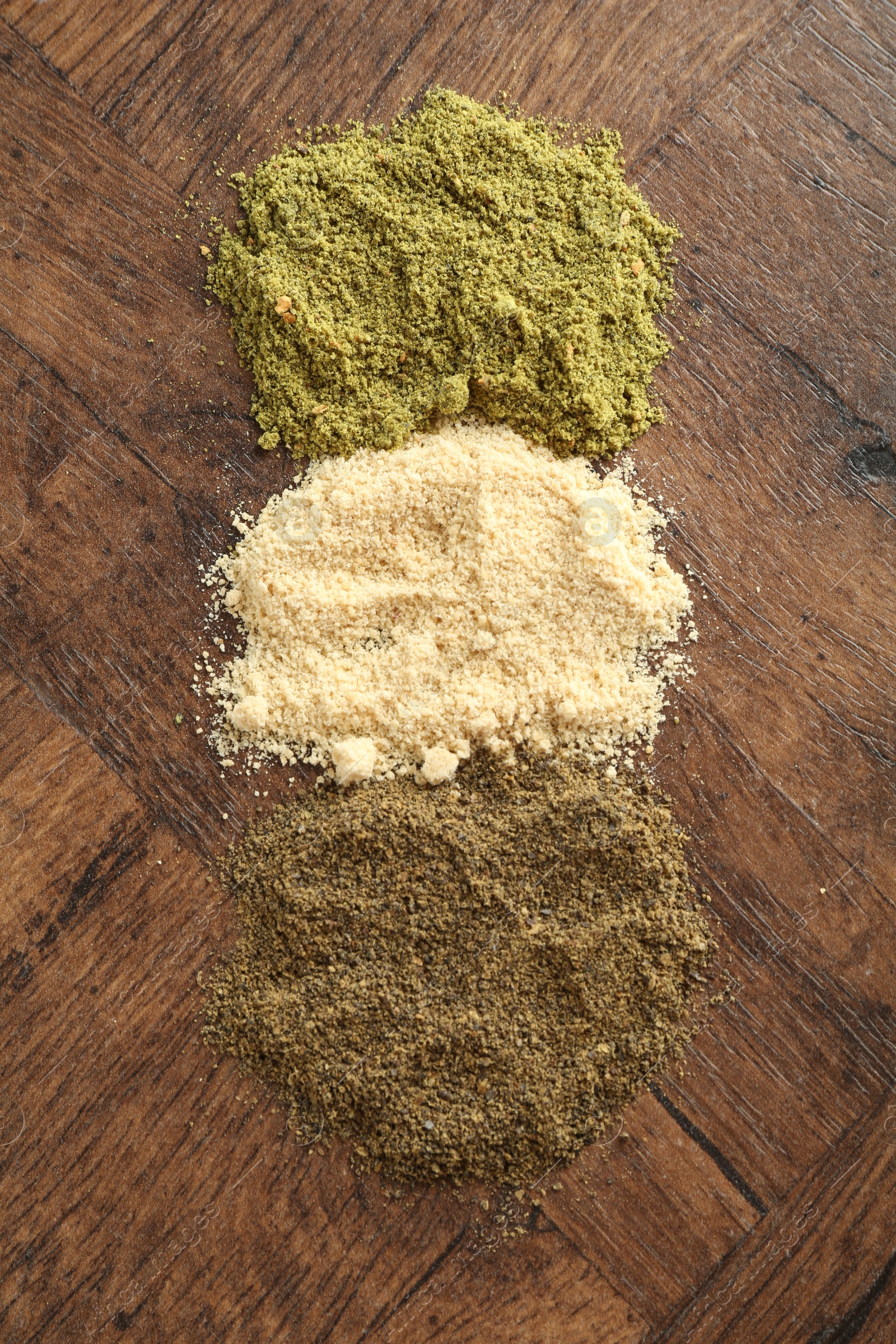 Photo of Different superfood powders on wooden table, above view