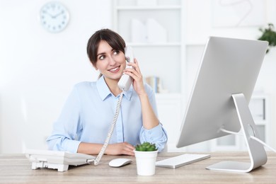 Photo of Portrait of receptionist at wooden desk in office