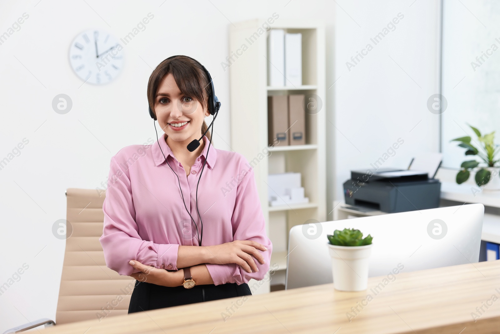 Photo of Portrait of receptionist at wooden desk in office