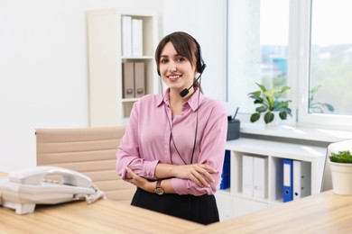 Photo of Portrait of receptionist at wooden desk in office