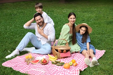 Happy family having picnic together in park