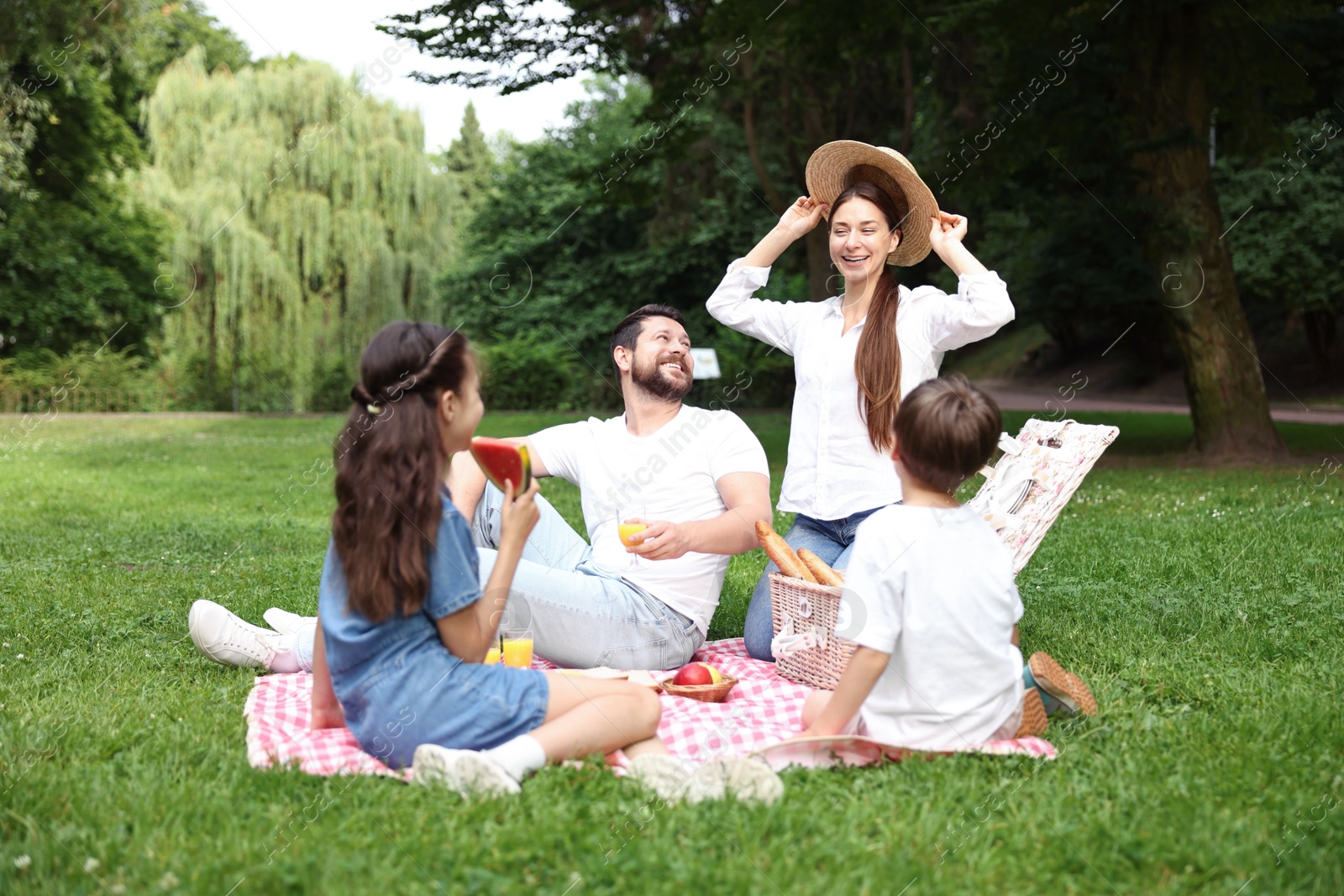 Photo of Happy family having picnic together in park