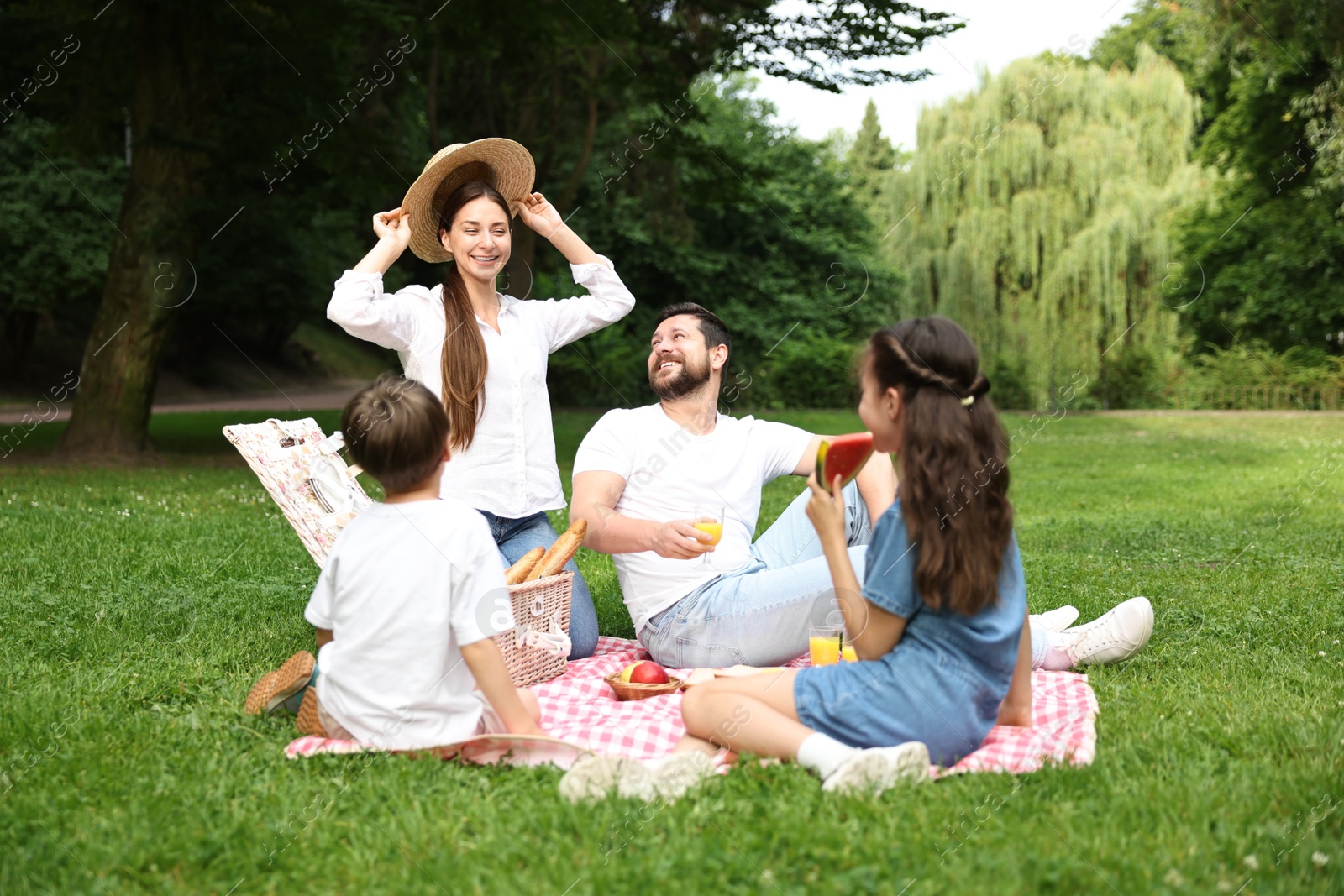 Photo of Happy family having picnic together in park