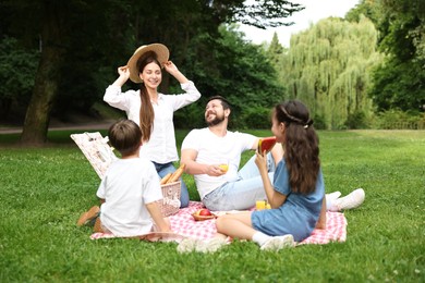 Happy family having picnic together in park