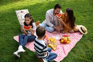 Happy family having picnic together in park