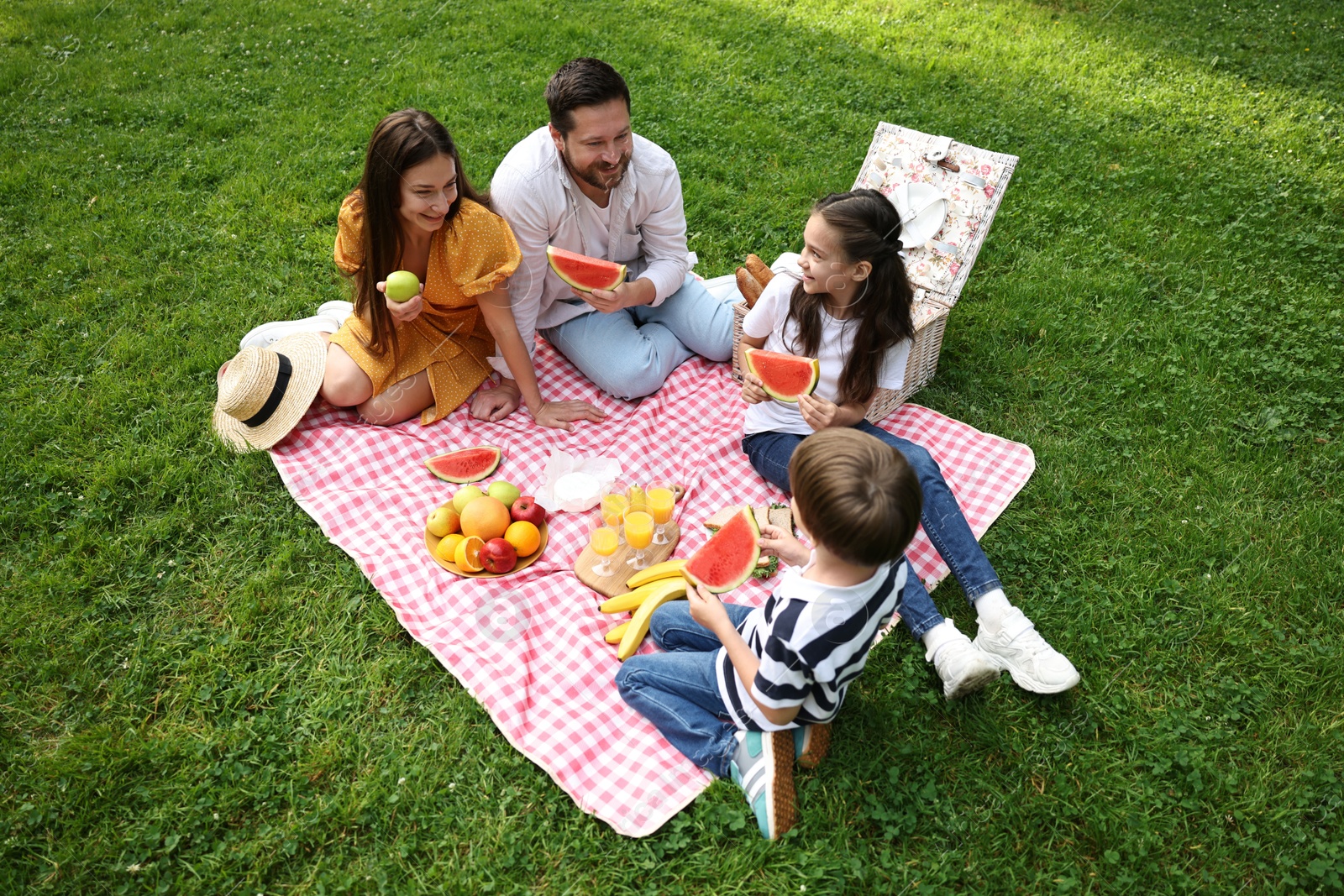 Photo of Happy family having picnic together in park