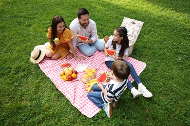 Happy family having picnic together in park