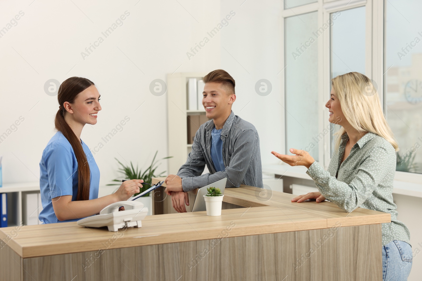 Photo of Professional receptionist working with patients in hospital