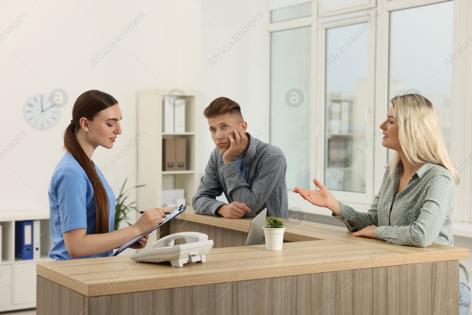 Photo of Professional receptionist working with patients in hospital