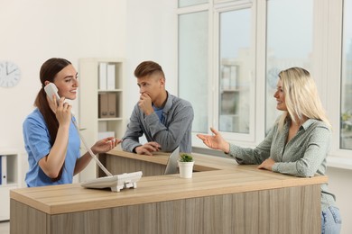 Photo of Professional receptionist working with patients in hospital