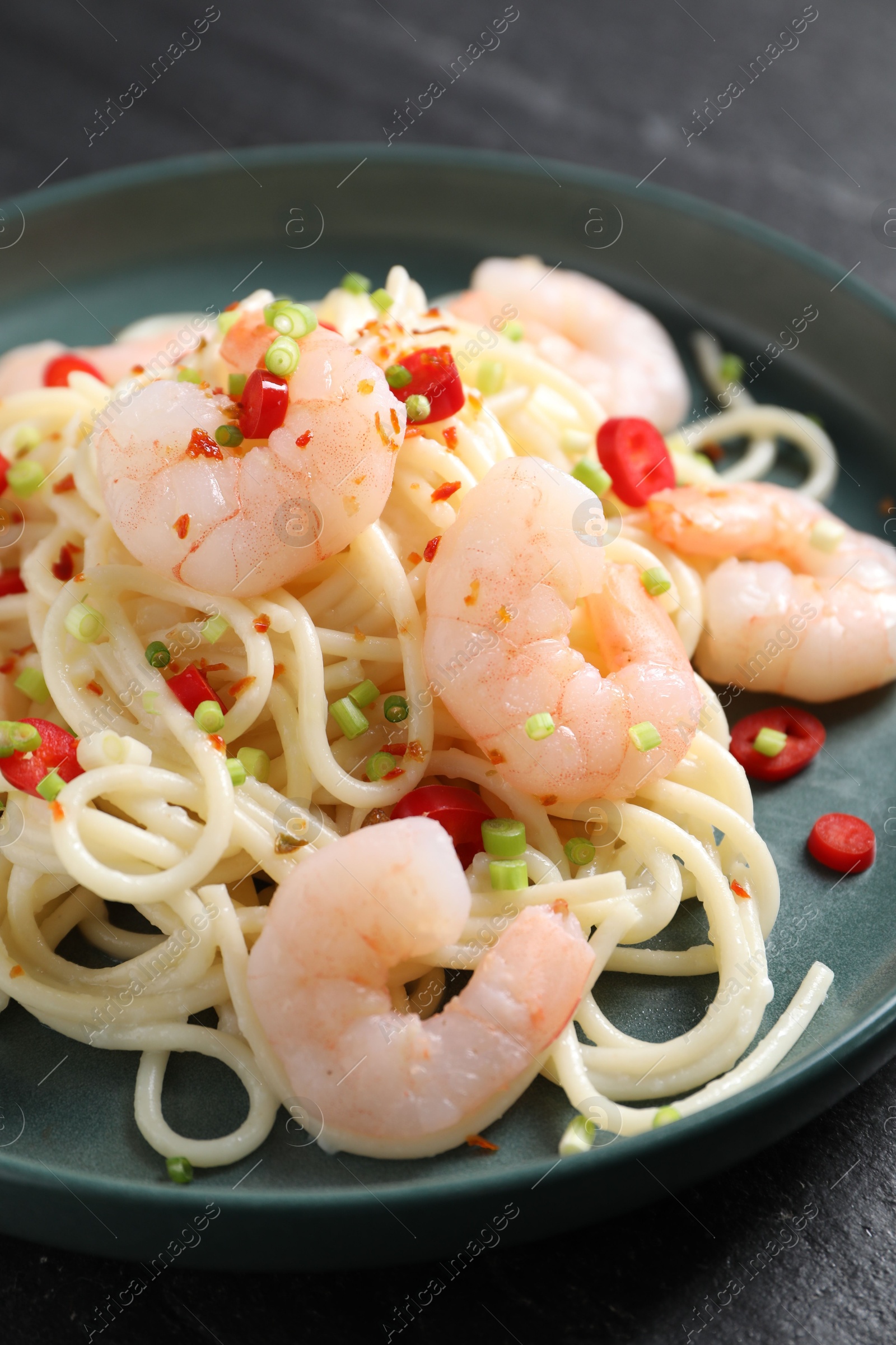 Photo of Delicious pasta with shrimps, green onion and chili pepper on table, closeup