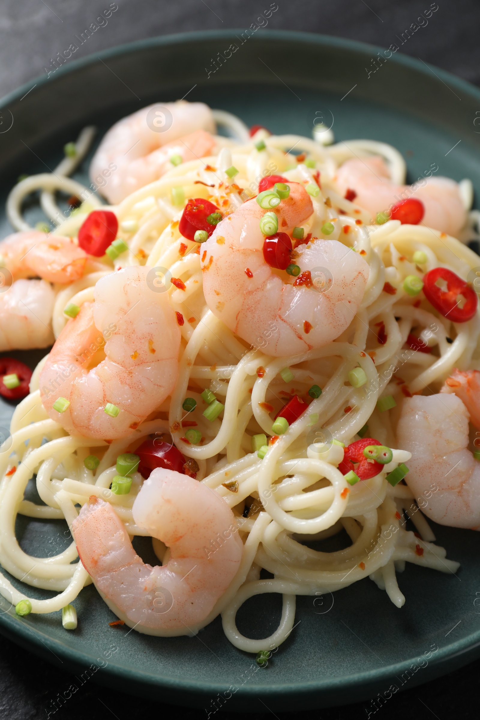 Photo of Delicious pasta with shrimps, green onion and chili pepper on table, closeup