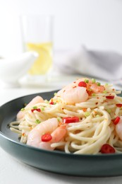 Photo of Delicious pasta with shrimps, green onion and chili pepper on white table, closeup