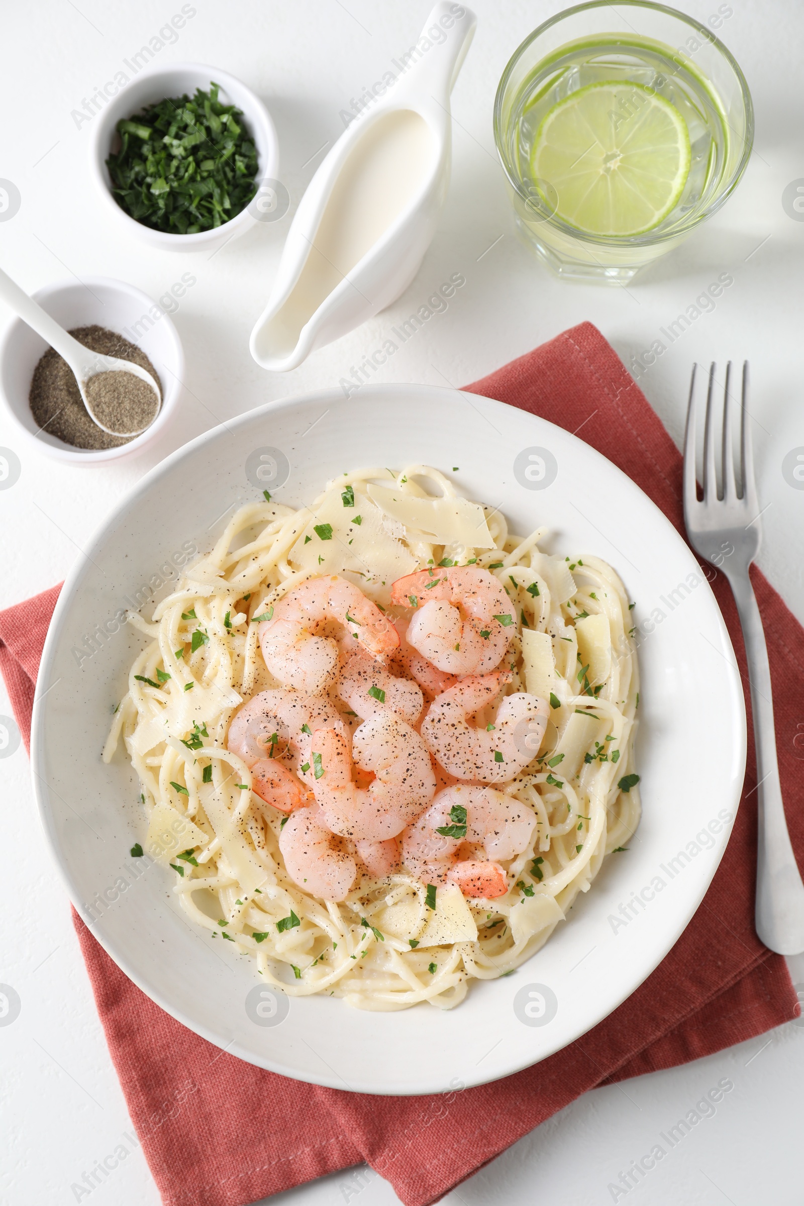 Photo of Delicious pasta with shrimps and cheese served on white table, top view