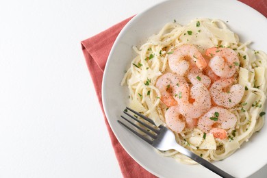 Photo of Delicious pasta with shrimps and cheese on white table, top view. Space for text