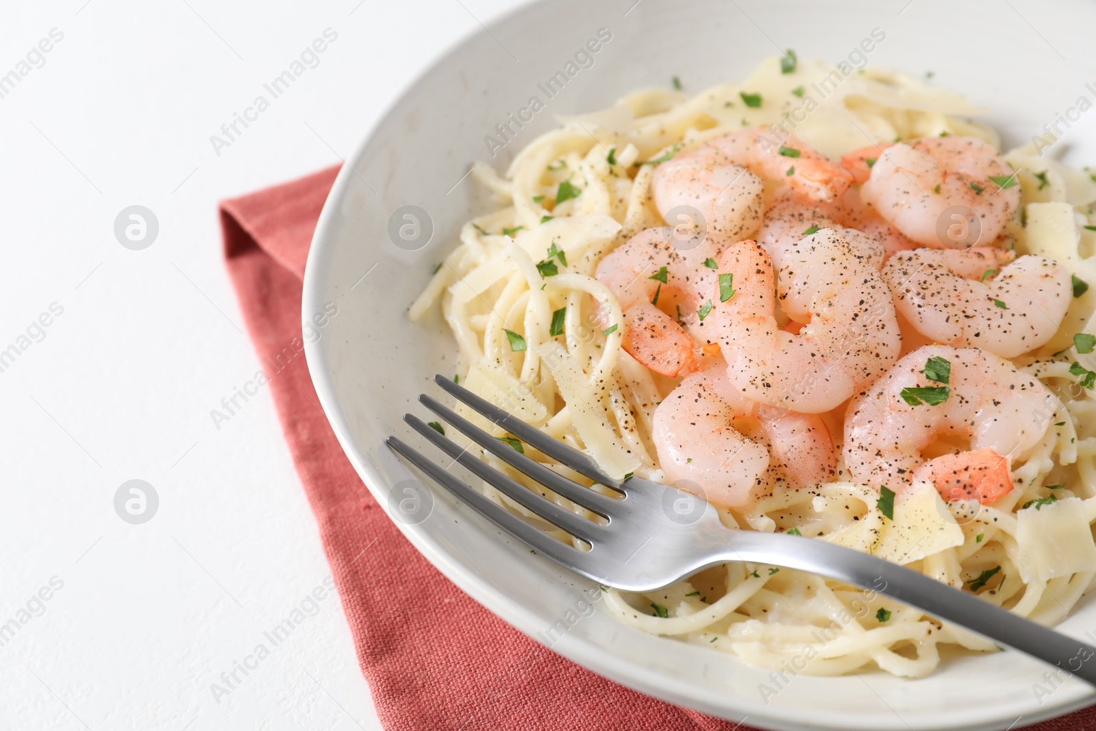 Photo of Delicious pasta with shrimps and cheese on white table, closeup