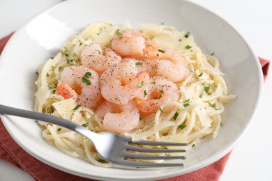 Photo of Delicious pasta with shrimps and cheese on white table, closeup