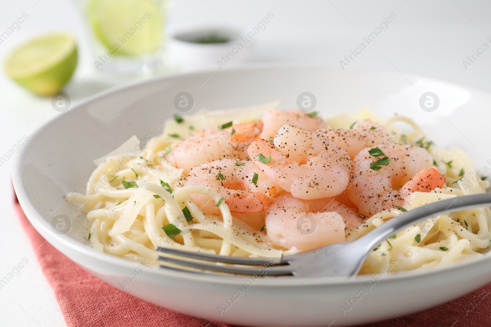 Photo of Delicious pasta with shrimps and cheese on table, closeup