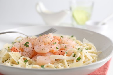 Photo of Delicious pasta with shrimps and cheese on table, closeup