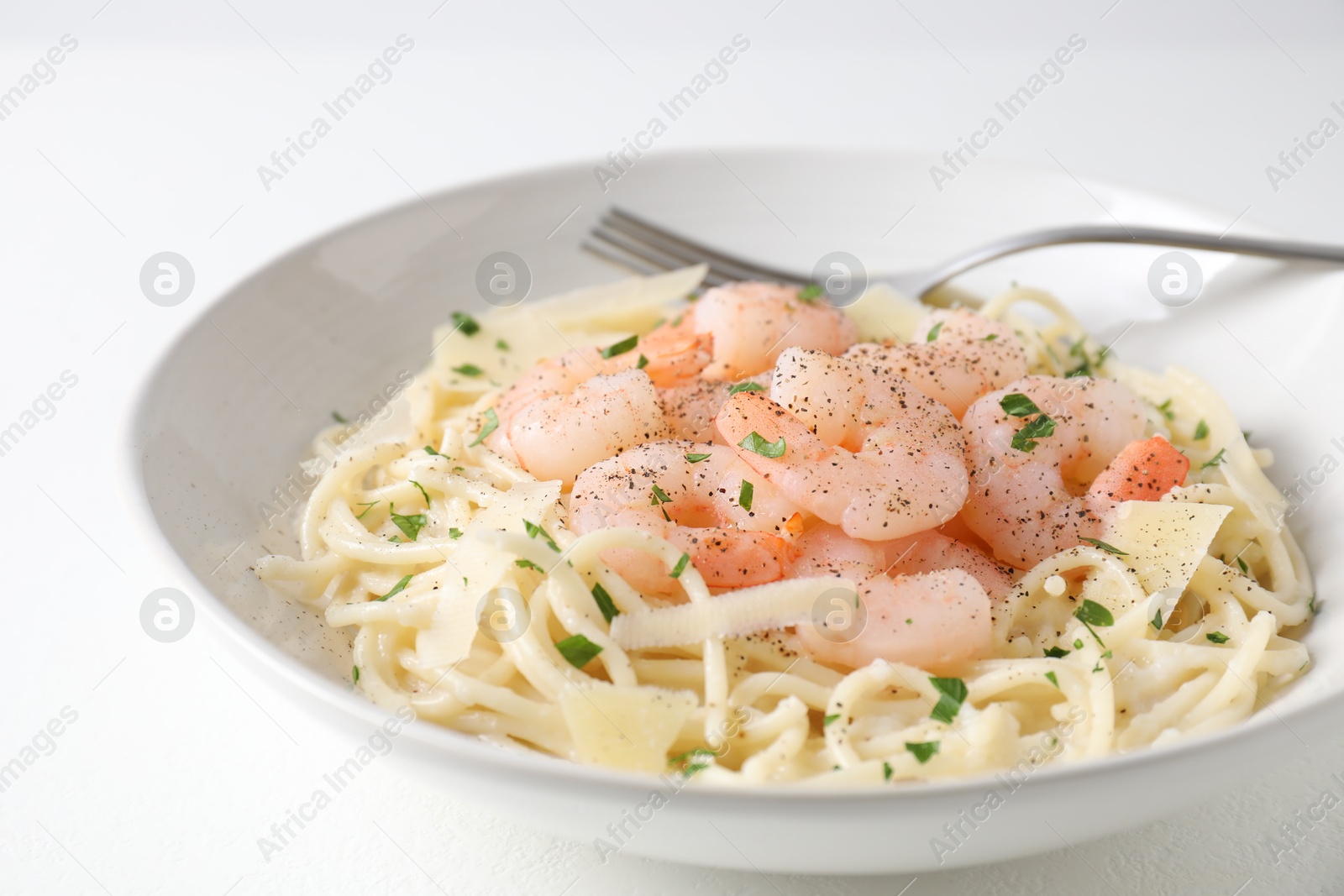 Photo of Delicious pasta with shrimps and cheese on white table, closeup