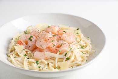 Photo of Delicious pasta with shrimps and cheese on white table, closeup