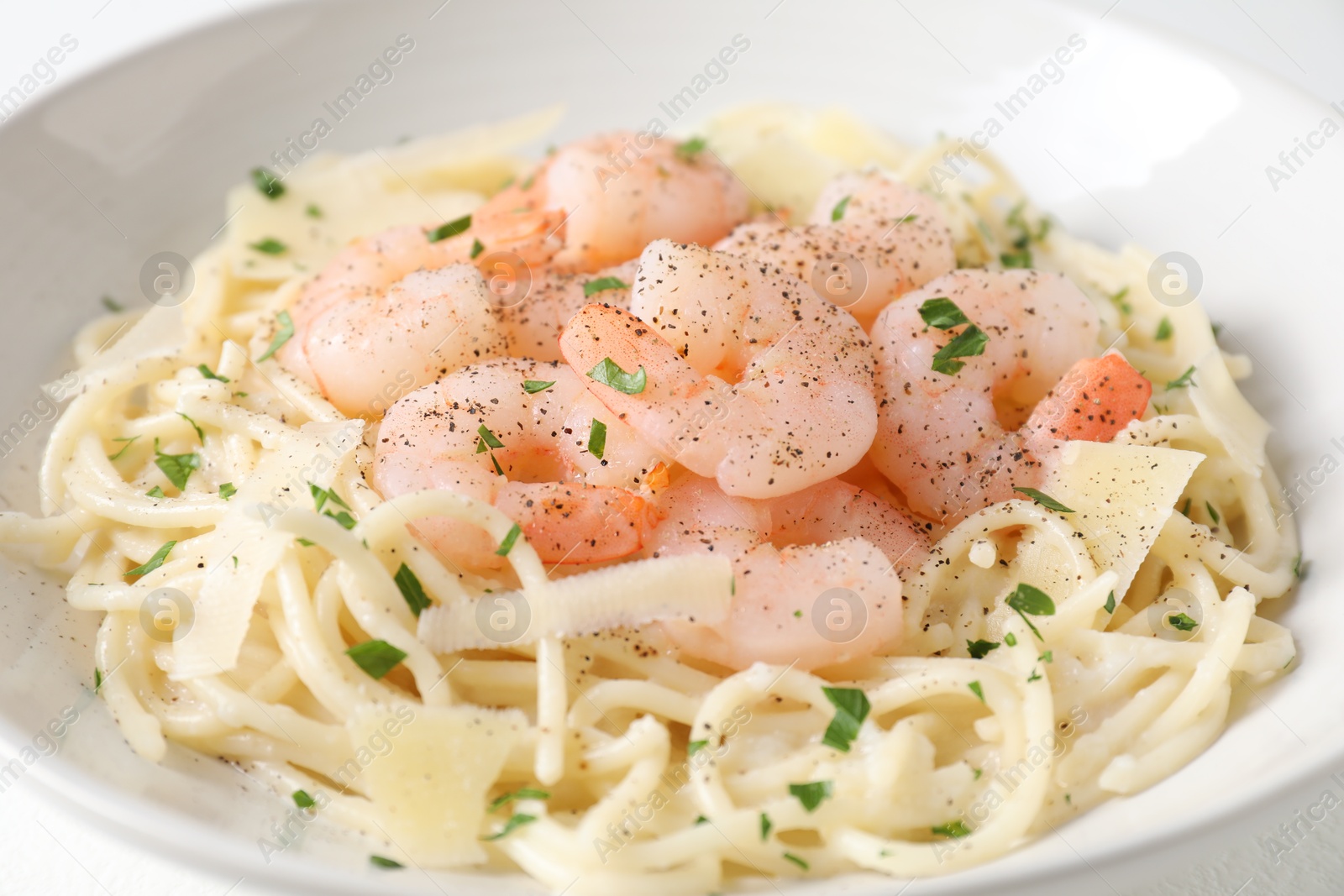 Photo of Delicious pasta with shrimps and cheese on table, closeup