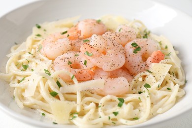 Photo of Delicious pasta with shrimps and cheese on table, closeup