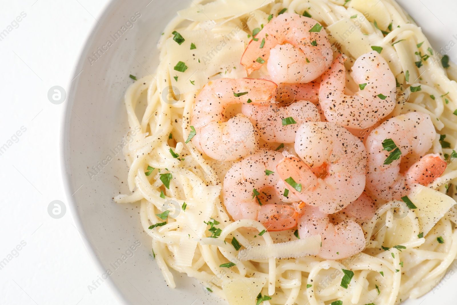 Photo of Delicious pasta with shrimps and cheese on white table, top view