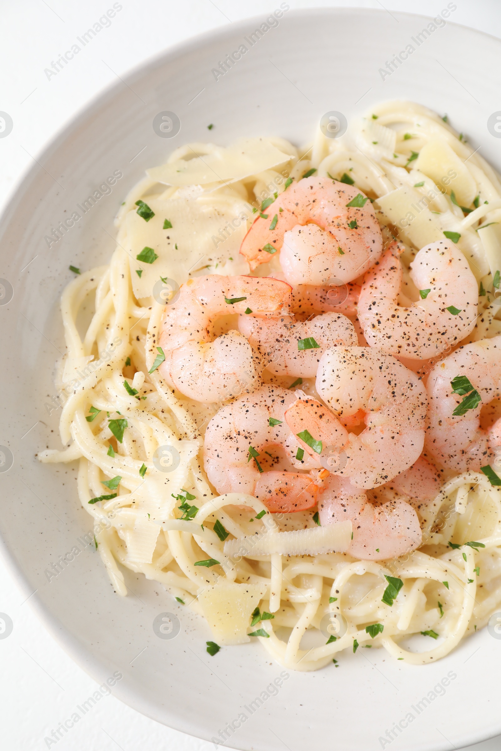 Photo of Delicious pasta with shrimps and cheese on white table, above view