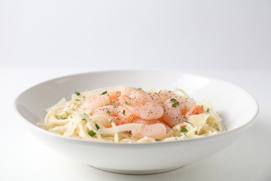 Photo of Delicious pasta with shrimps and cheese on white table, closeup