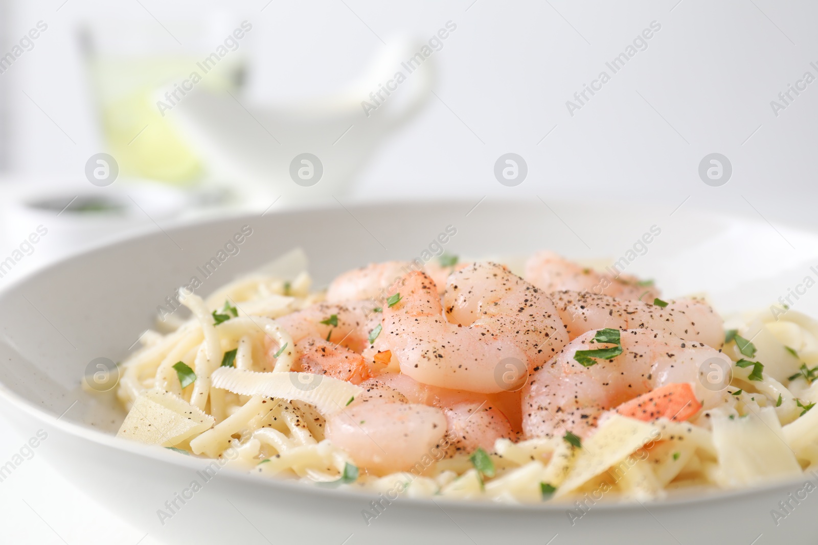 Photo of Delicious pasta with shrimps and cheese on table, closeup