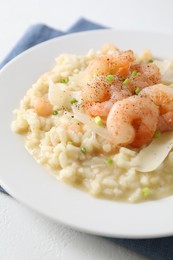 Photo of Delicious risotto with shrimps and cheese on white table, closeup