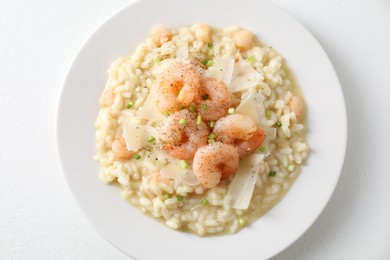 Photo of Delicious risotto with shrimps and cheese on white table, top view