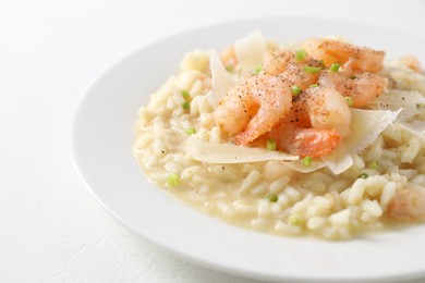 Photo of Delicious risotto with shrimps and cheese on white table, closeup