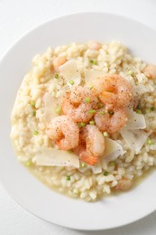 Photo of Delicious risotto with shrimps and cheese on white table, top view