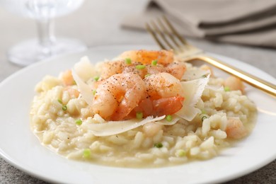 Photo of Delicious risotto with shrimps and cheese on table, closeup