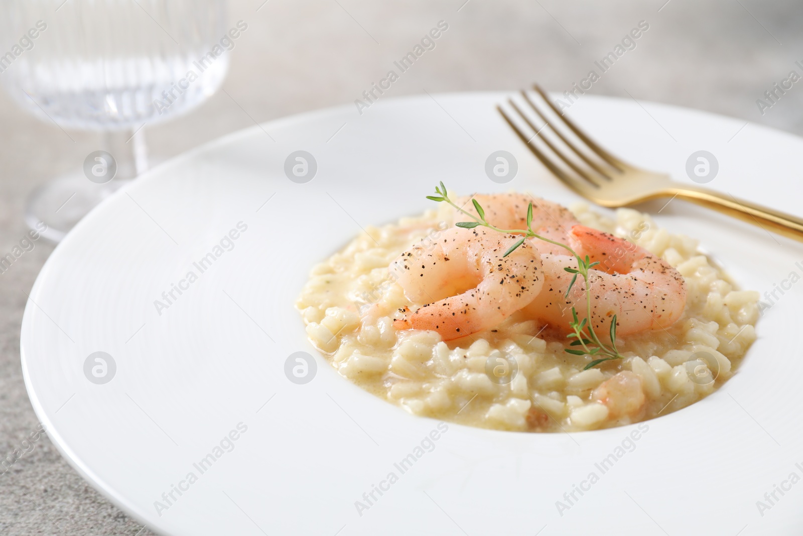 Photo of Delicious risotto with shrimps and cheese on table, closeup