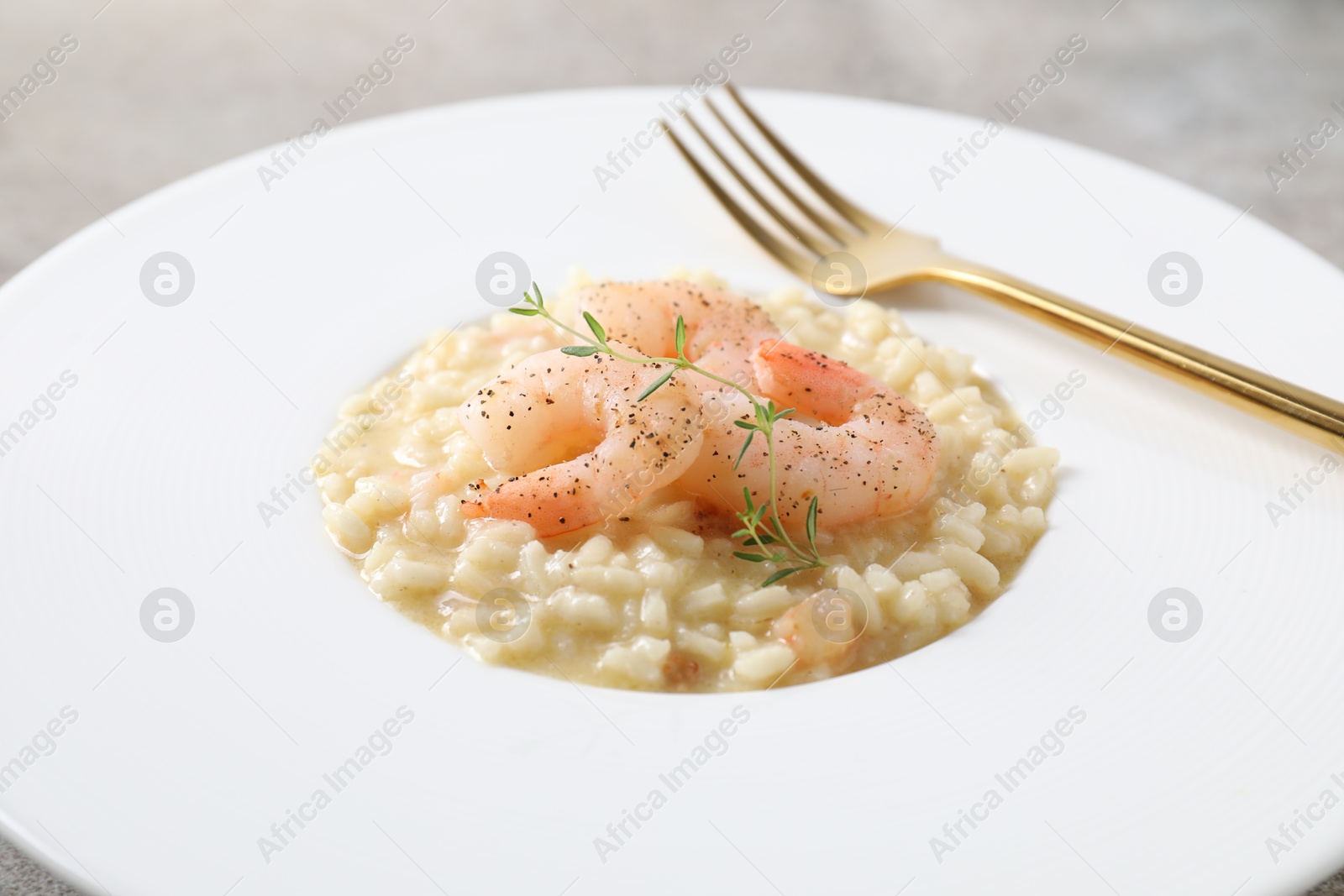 Photo of Delicious risotto with shrimps and cheese on table, closeup