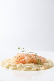 Photo of Delicious risotto with shrimps and cheese on plate, closeup