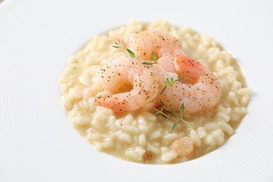 Photo of Delicious risotto with shrimps and cheese on plate, closeup