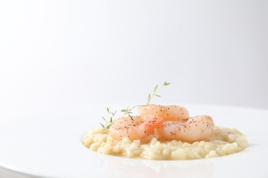 Photo of Delicious risotto with shrimps and cheese on plate, closeup