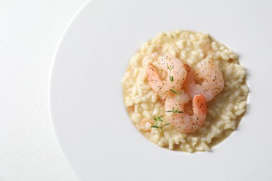 Photo of Delicious risotto with shrimps and cheese on white table, top view