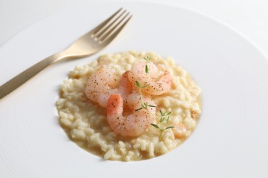 Photo of Delicious risotto with shrimps and cheese on plate, closeup