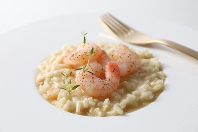 Delicious risotto with shrimps and cheese on plate, closeup