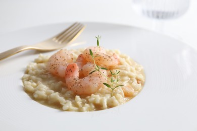 Photo of Delicious risotto with shrimps and cheese on plate, closeup