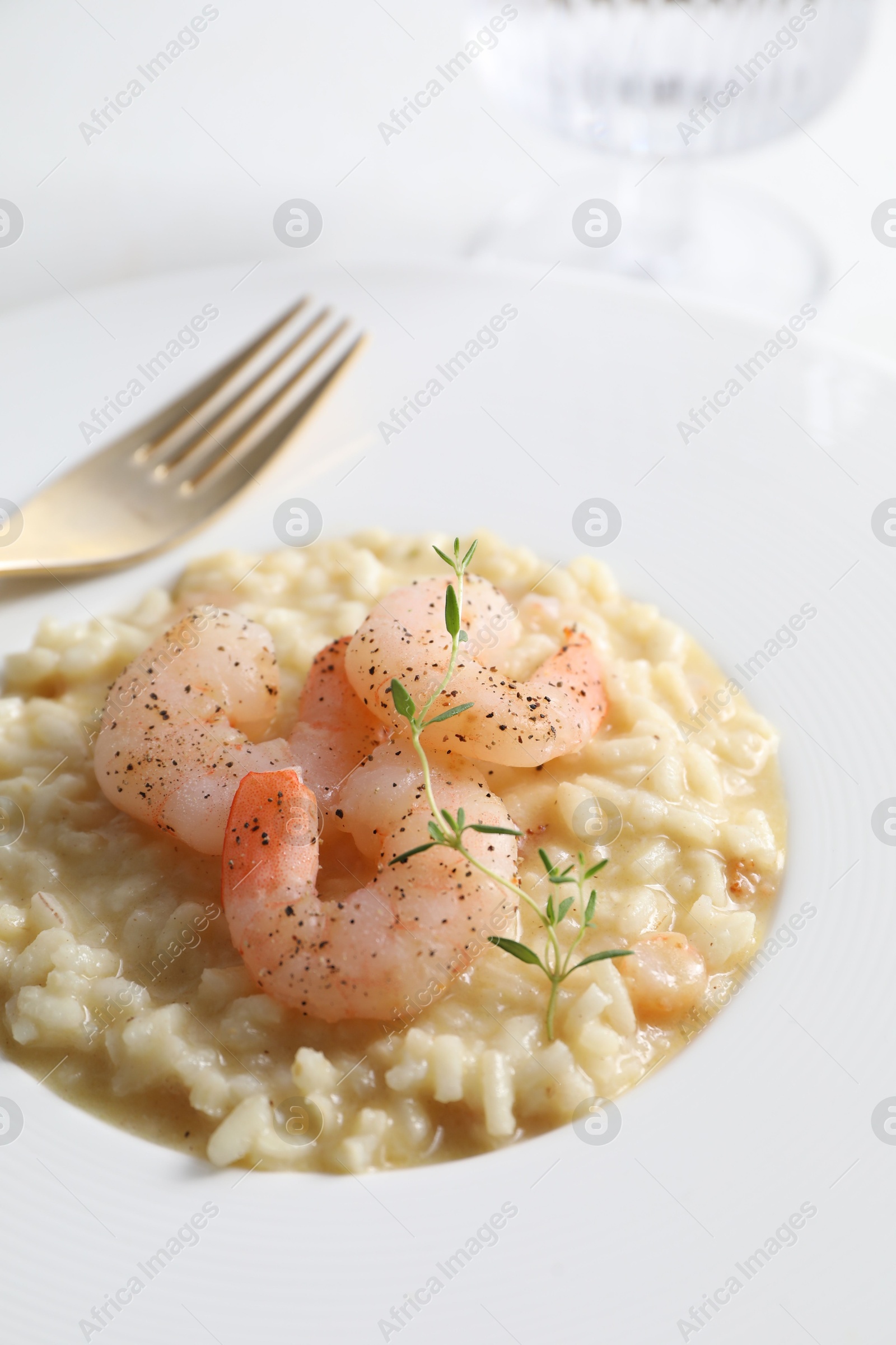 Photo of Delicious risotto with shrimps and cheese on plate, closeup