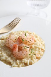 Photo of Delicious risotto with shrimps and cheese on plate, closeup