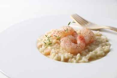 Photo of Delicious risotto with shrimps and cheese on plate, closeup