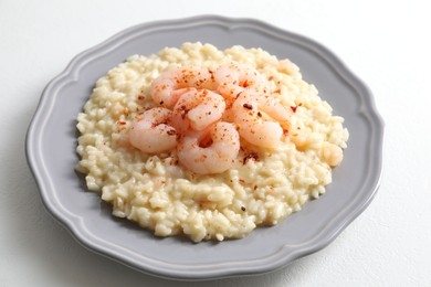 Photo of Delicious risotto with shrimps and cheese on white table, closeup