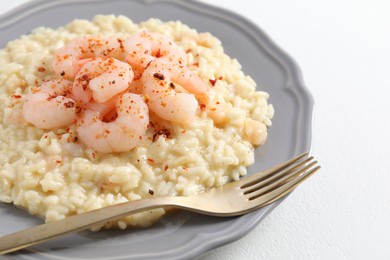 Photo of Delicious risotto with shrimps and cheese on white table, closeup